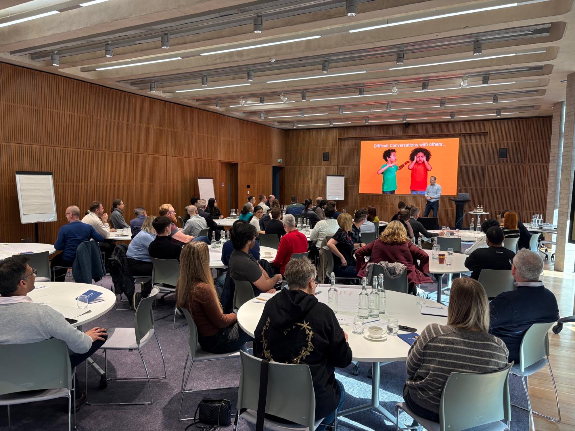 Mark Whybrow facilitating a leadership development session with a large client group